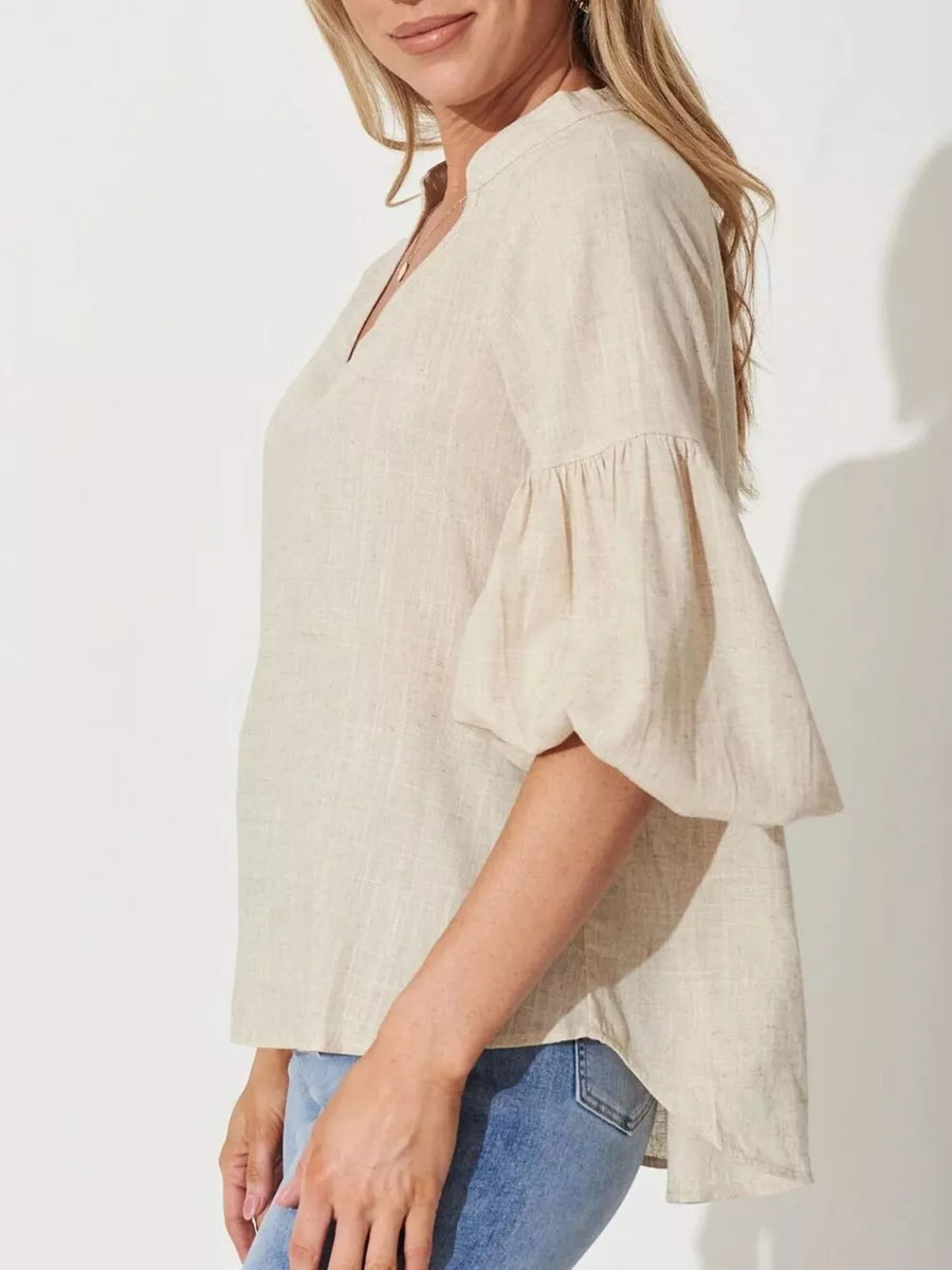 Maternity shirt in beige linen-blend with notched V-neck and balloon sleeves.