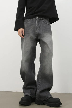 Faded dark gray denim jeans with a wide-leg silhouette and cotton material.