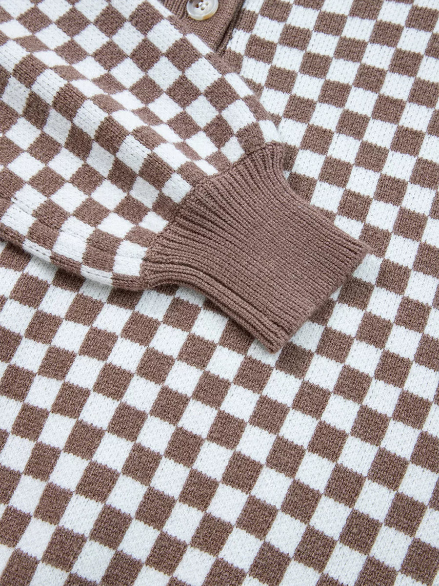 cream pullover sweater with half-button and checkerboard