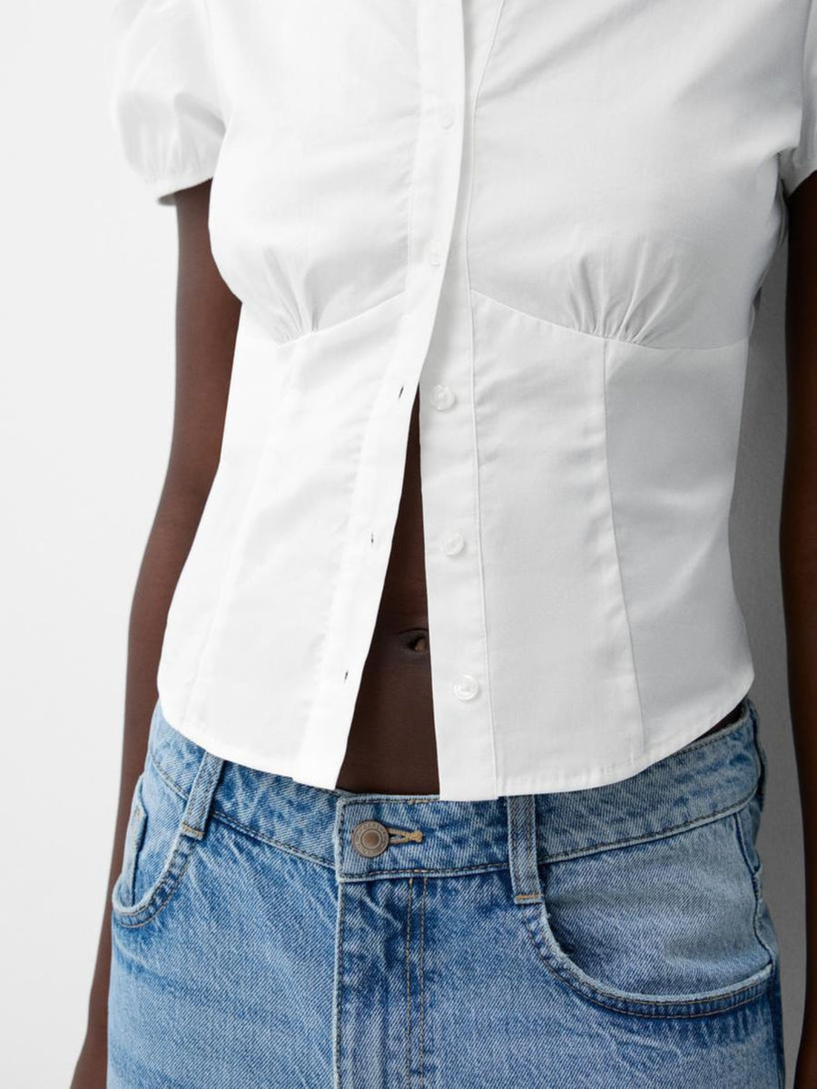 White puff sleeve fitted button-up shirt with ruched detailing and cropped length.