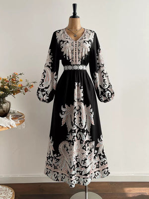 Black maxi dress with V-neck, balloon sleeves, and ornate paisley print.