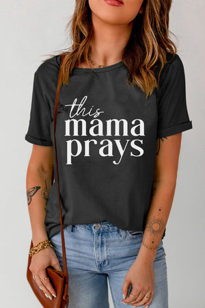 Black graphic tee with white "this mama prays" script, crew neck, short sleeves.
