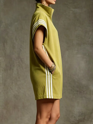 Mustard color zip-up romper with white stripes on sleeves and sides, featuring pockets.