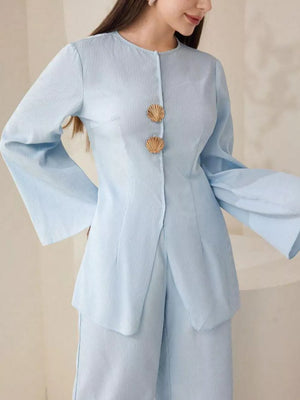 Light blue crinkled texture two-piece set with shell buttons and bell sleeves.