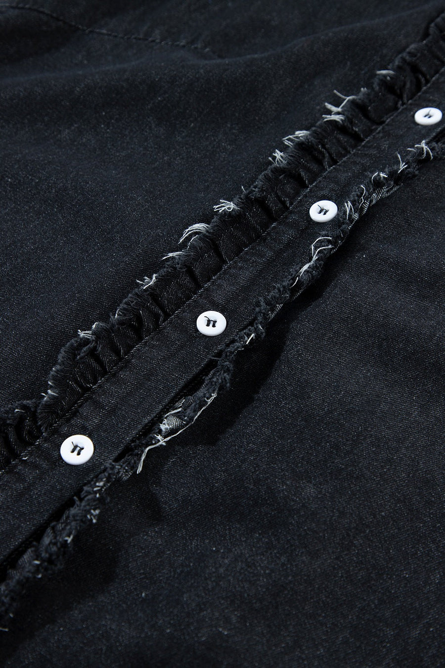Black denim button-up shirt with frayed ruffle trim and white buttons.