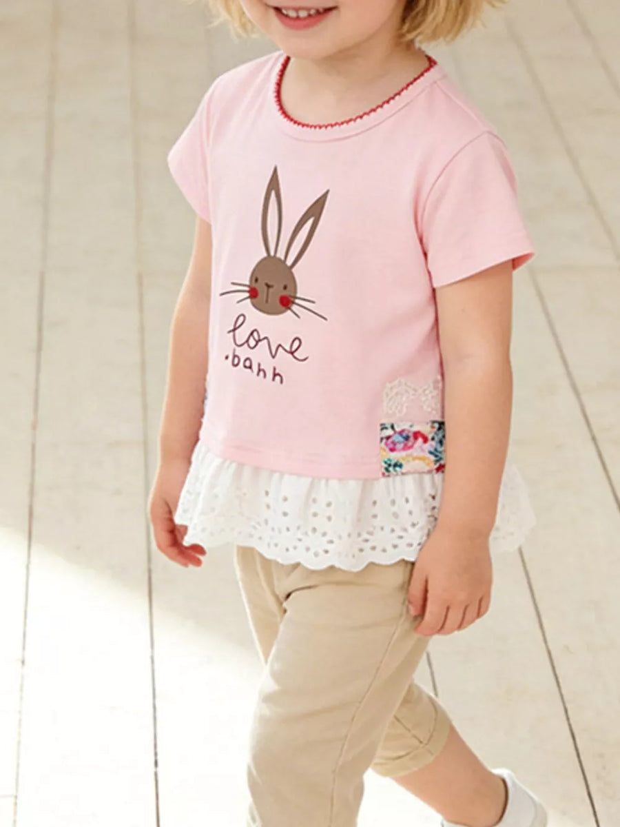 Pink cotton tee with bunny graphic, lace trim, and ruffled hem.