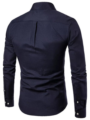 Navy button-down cotton shirt with a back pleat detail and buttoned cuffs.