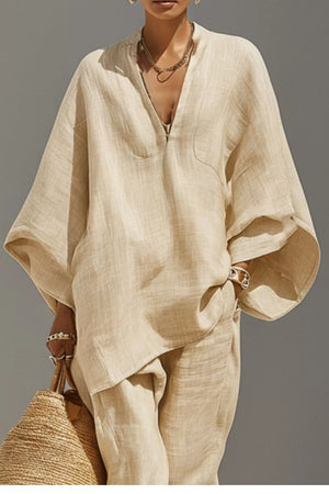 Chic relaxed beige linen two-piece set with V-neck tunic and pocket detail.