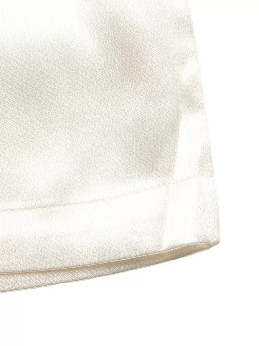 Beige maternity wide-leg trousers with a subtle texture and clean hem detail.