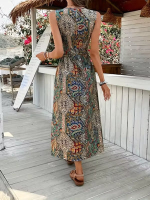 Maternity swim dress in multicolor paisley print with cinched waist and dramatic slit.