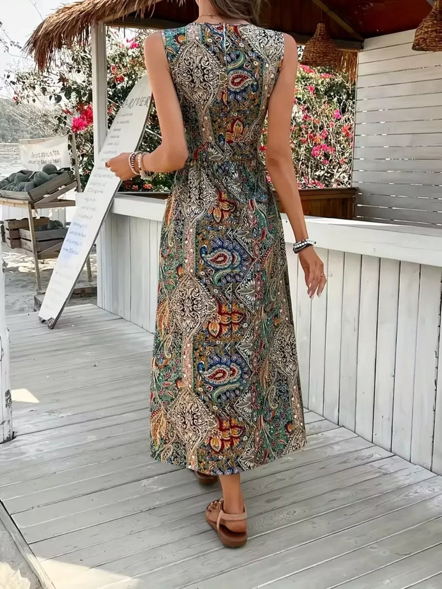 Maternity swim dress in multicolor paisley print with cinched waist and dramatic slit.