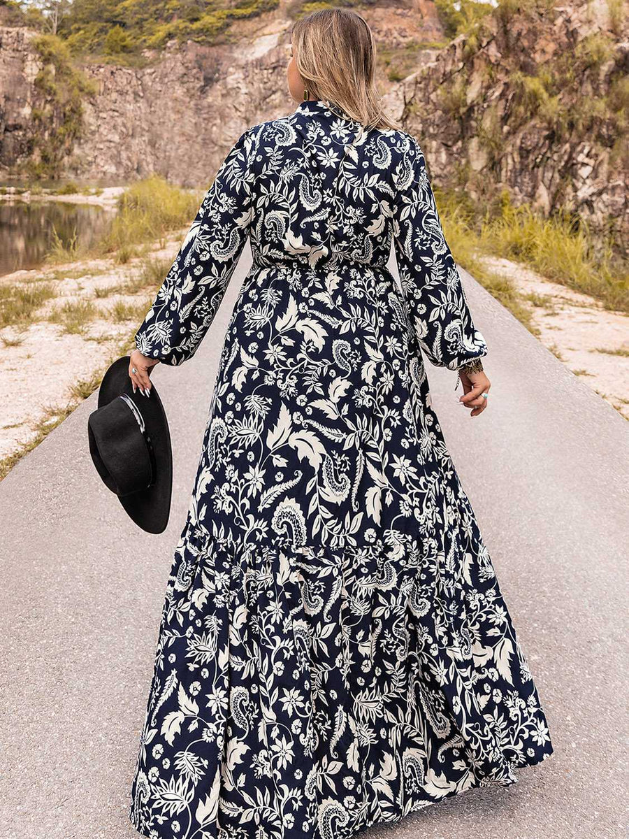 Dark navy paisley print tiered maxi dress with long sleeves and a tie waist.
