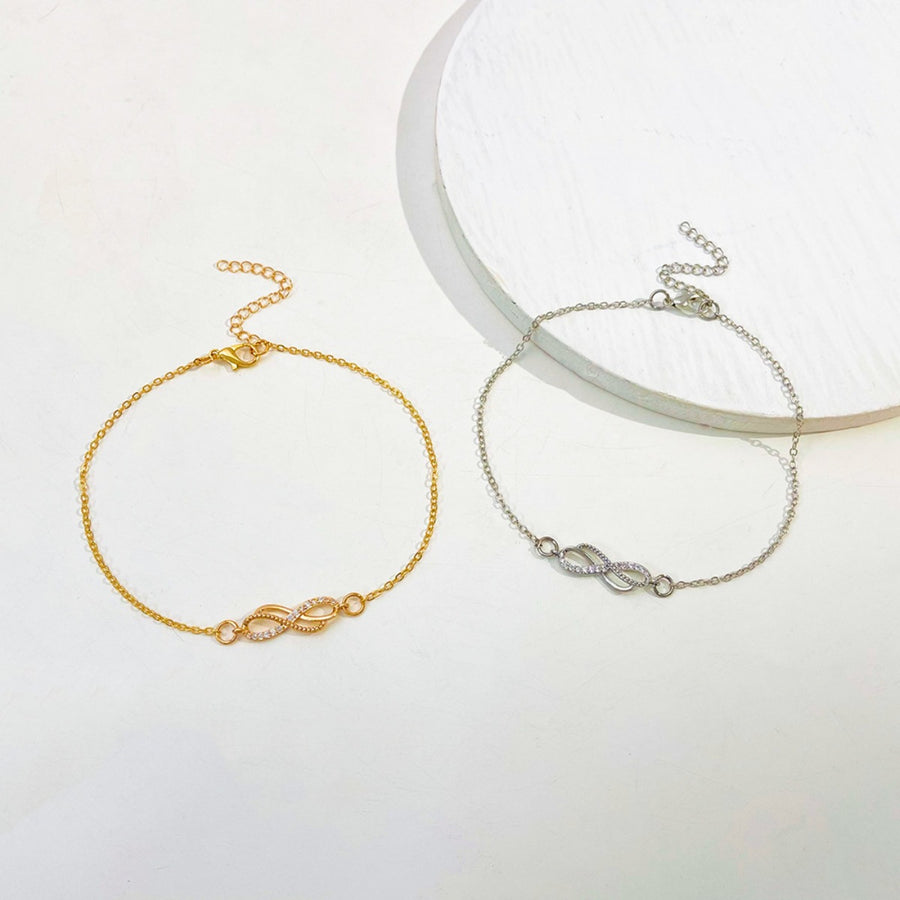 Gold and silver infinity knot charm bracelets with adjustable chains