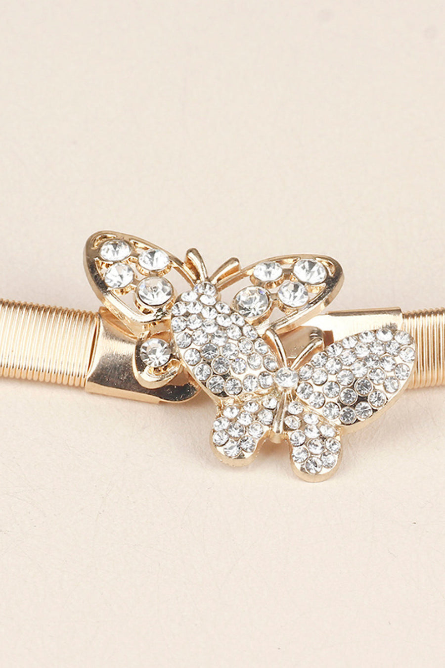 Gold belt with a double crystal butterfly clasp closure.