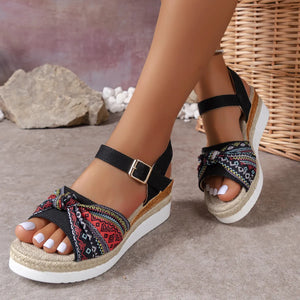 Embroidered knot espadrille platform sandals with ankle strap and buckle.