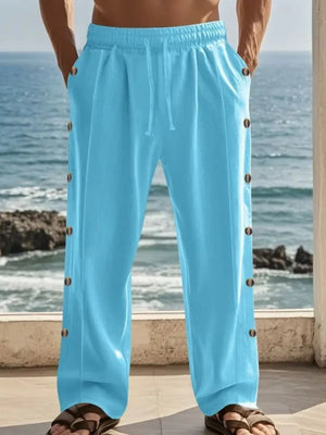 Pastel blue linen palazzo trousers with side buttons and drawstring waist.