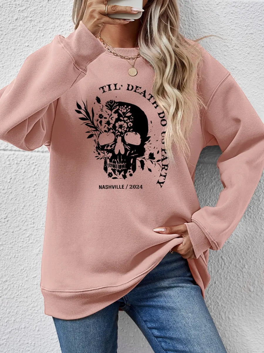 Blush Pink raglan sweatshirt with floral skull graphic and text.