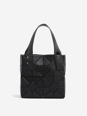 handbag in black featuring geometric panels and boxy fit