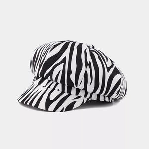 black hat featuring brim and cow-print