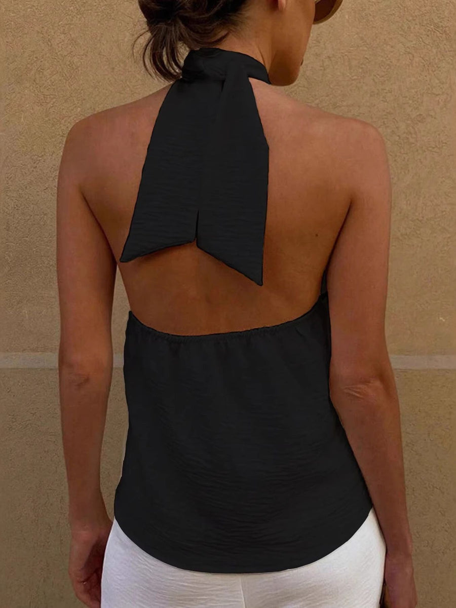 Black backless halter cami with a twisted tie detail at the neck.