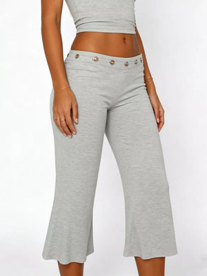 Light gray flared hem capri pants with button detail at the waist