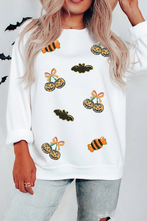 orange pullover sweater featuring sequin embellishment and graphic print