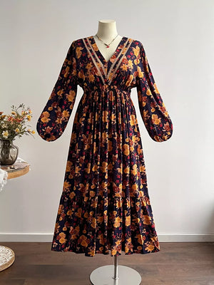 Maxi dress with V-neck, long sleeves, tiered skirt, and floral print.