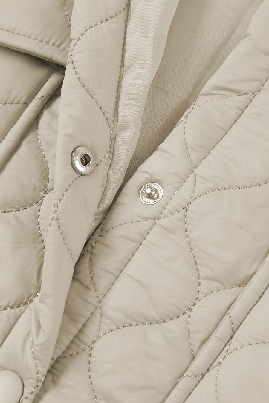Camel quilted utility jacket with snap closures and metallic stitching detail.