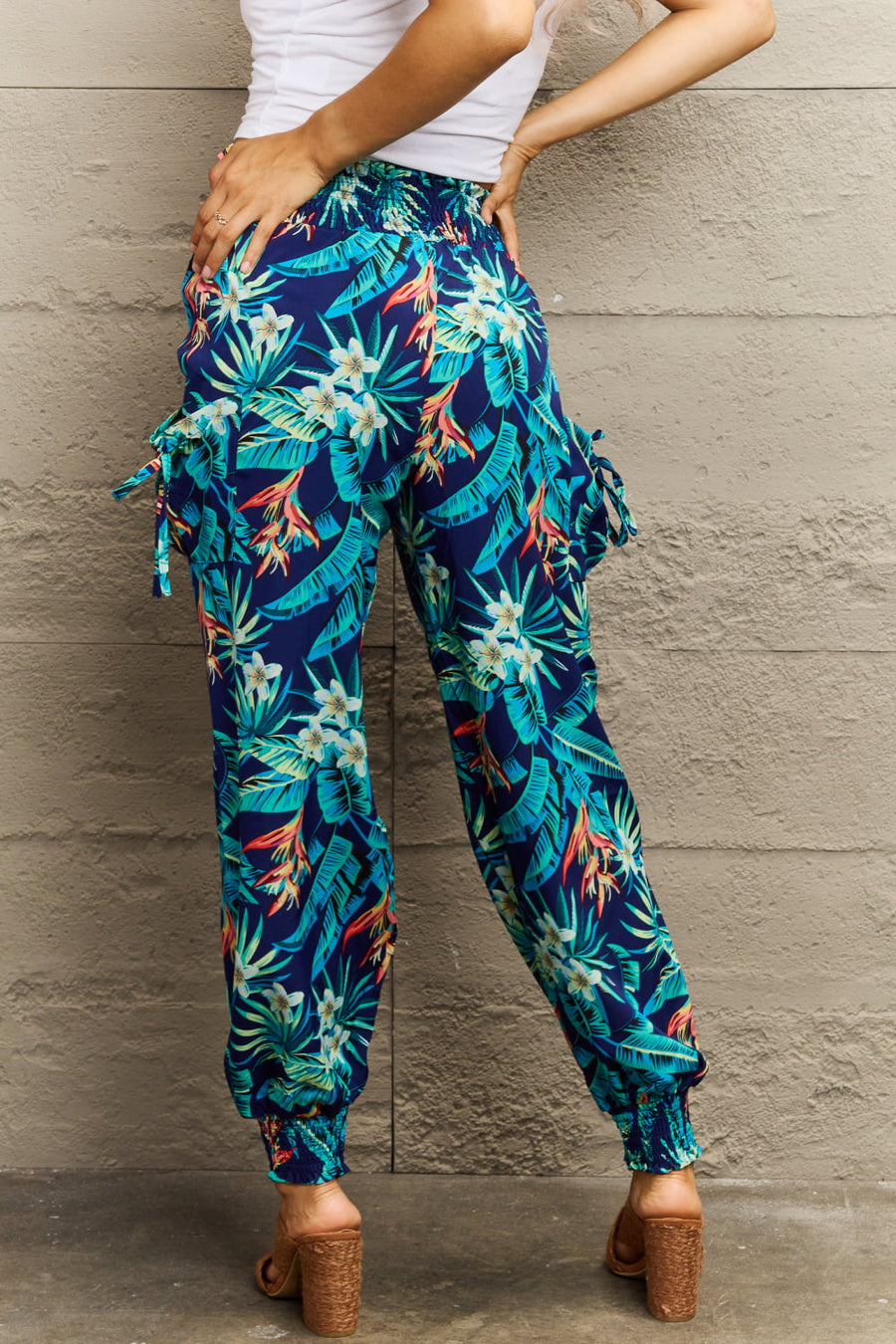 Tropical print cargo pants with gathered cuffs and tie details.