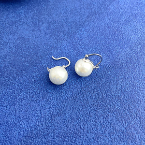 Plated pearl hoop earrings with silver findings and white pearls.