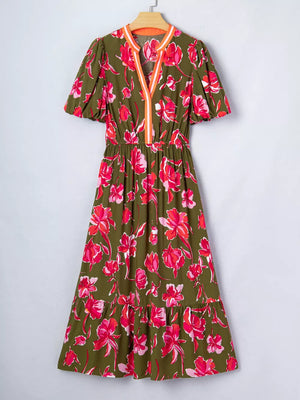 Print split neck dress with short puff sleeves, elastic waist, and tiered hem.