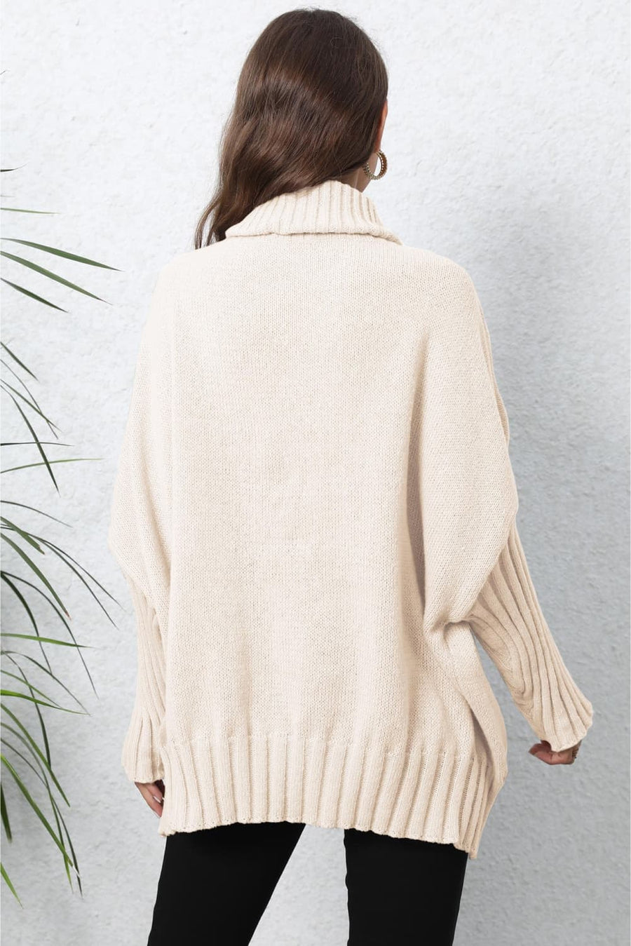 Beige ribbed turtleneck sweater with batwing sleeves and a relaxed fit.