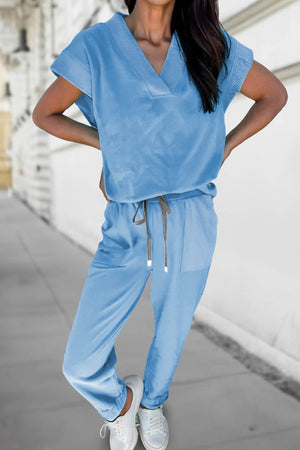 Light blue cotton drawstring loungewear set with v-neck top and pants.