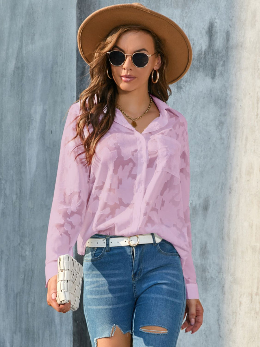 Pink sheer button-down blouse with floral embroidery and long sleeves.