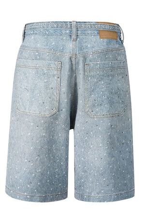 Embellished denim bermuda shorts in medium wash with allover rhinestones and tie detail.