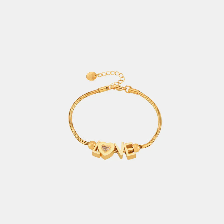 Gold adjustable bracelet with LOVE letter charms and a heart charm with pave details.