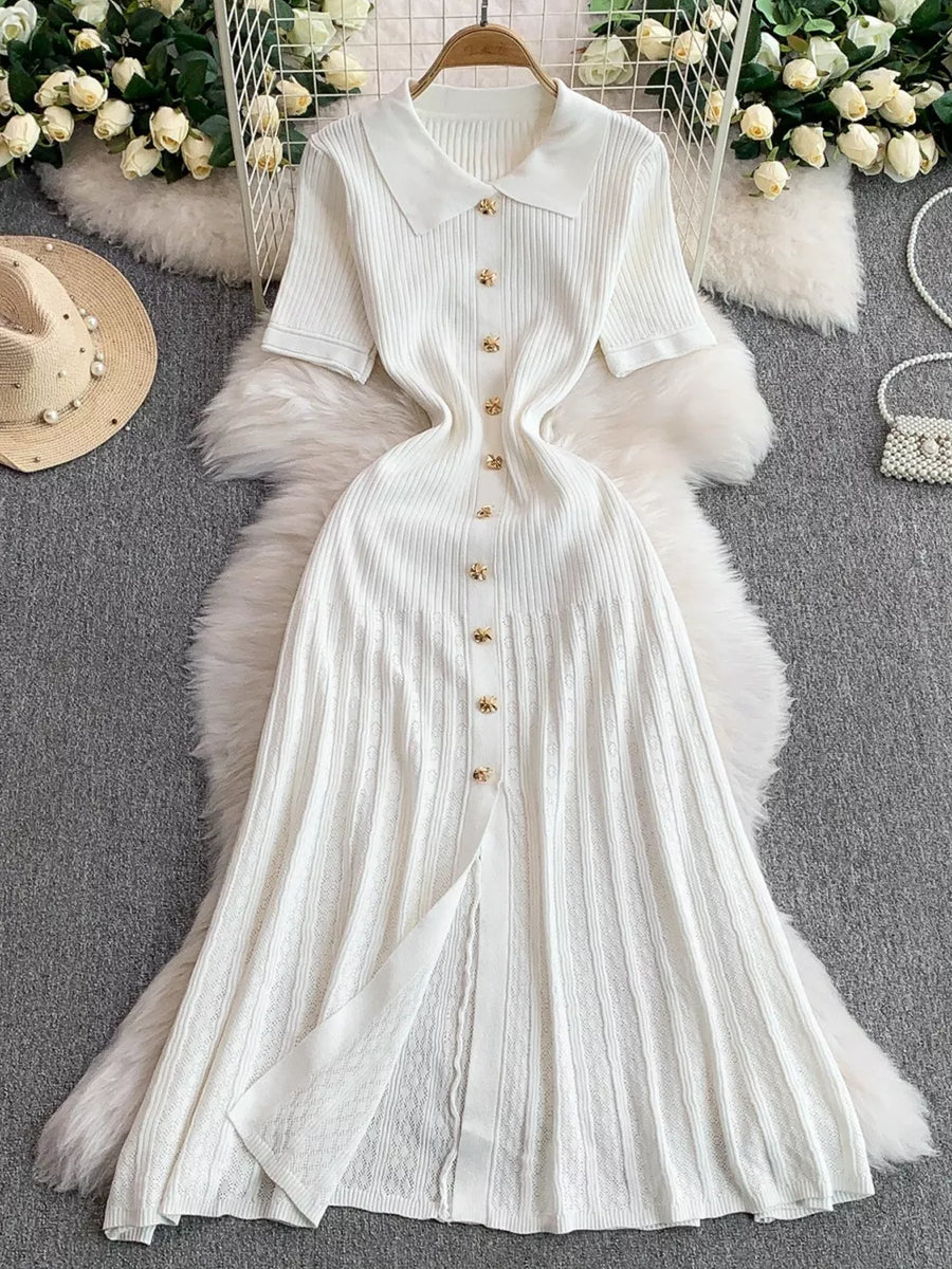 White ribbed knit midi dress with collar, short sleeves, and gold button detail.
