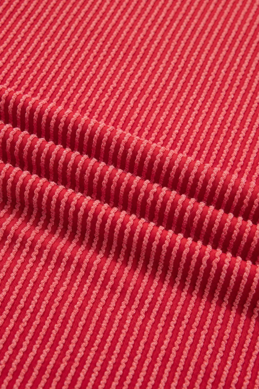 Red twisted rib t-shirt with subtle stripe texture and crew neck.