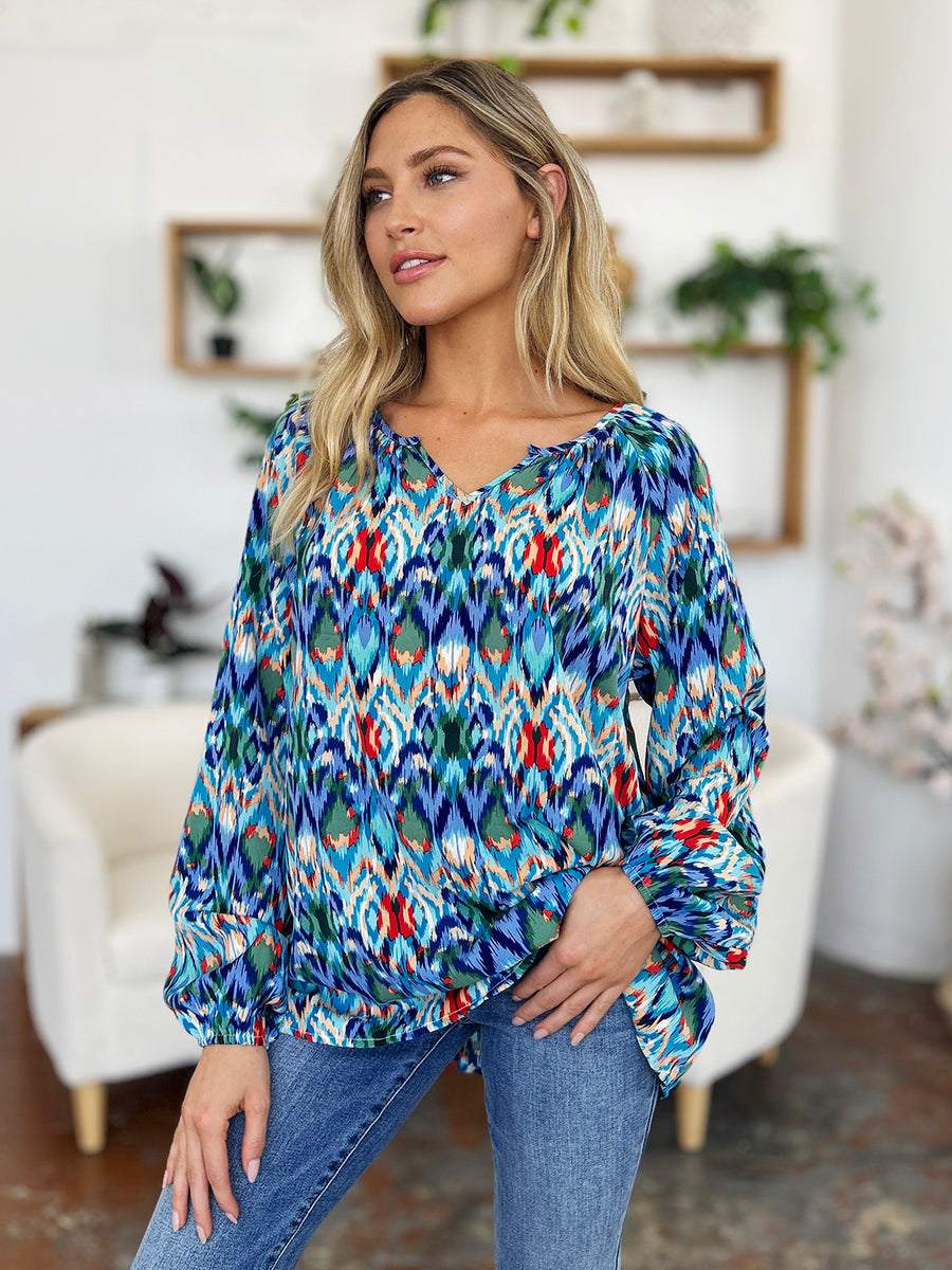 Prismatic ikat blouse with voluminous sleeves in blue and green, featuring a V-neck and relaxed fit.