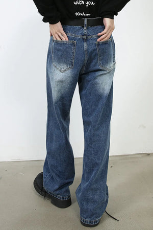 Panel seam wide leg denim jeans in medium wash with distressed details.