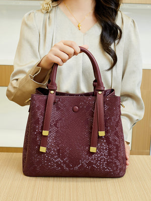 handbag in burgundy with snakeskin and top handles