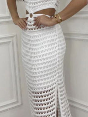 White crochet maxi set with cutout detail and side slit skirt.