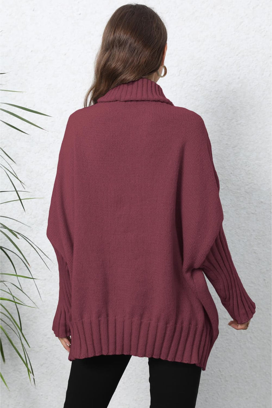 Burgundy ribbed knit turtleneck sweater with batwing sleeves and ribbed cuffs.