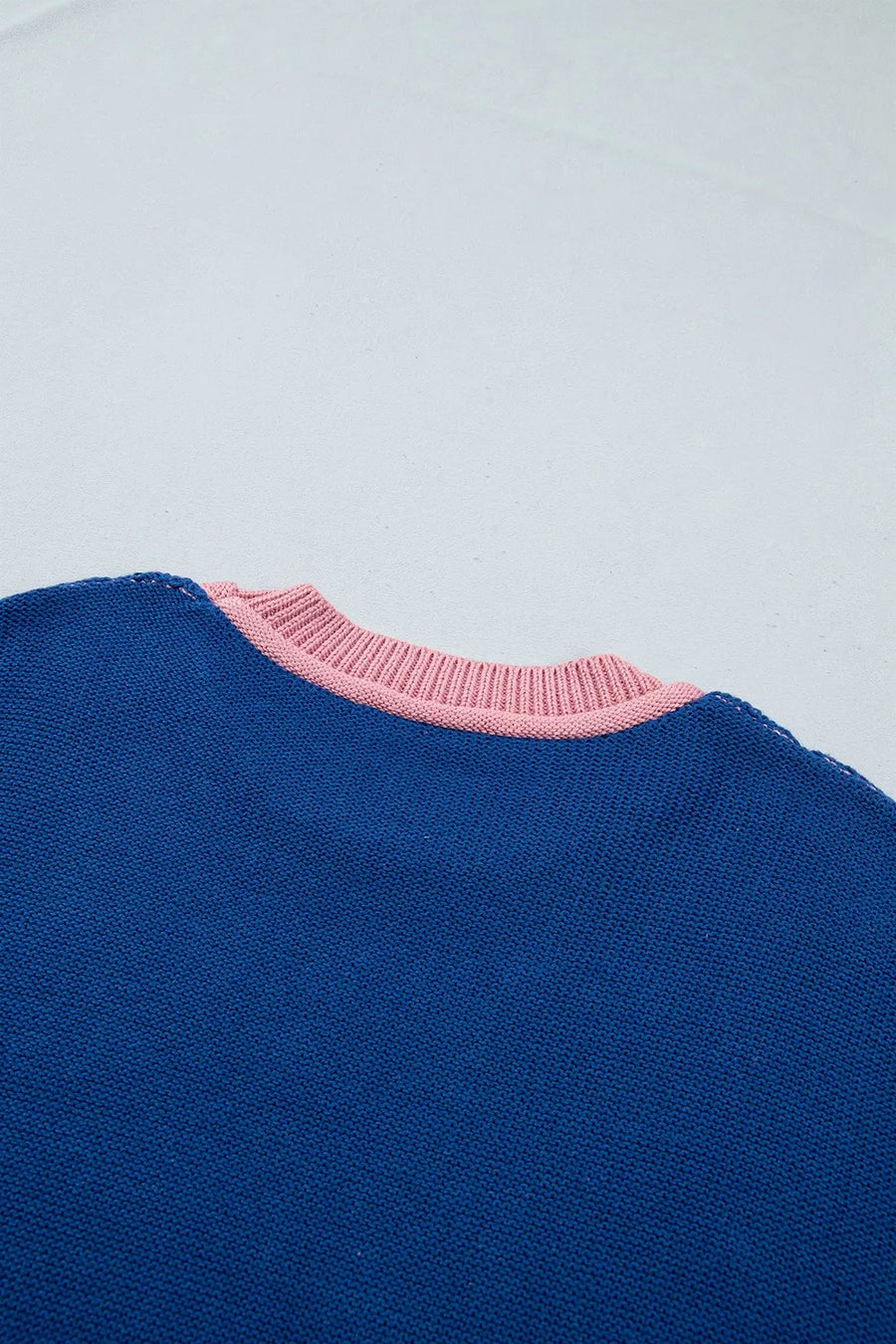 pullover sweater in olive green with exposed seam and hip-length