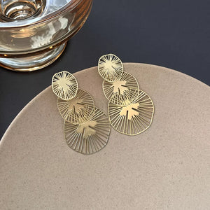 Gold earrings featuring drop earrings and geometric