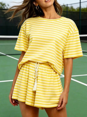 Yellow striped tee and drawstring shorts ensemble with tassel detail.