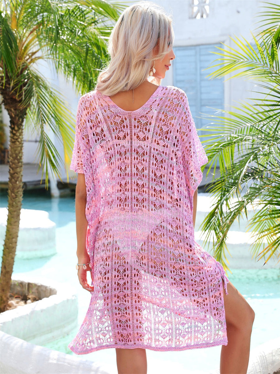Pink lace-knit kaftan cover up with side tie detail and open knit pattern.