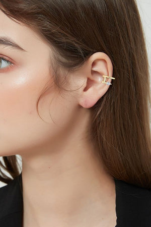 Gold spiral ear cuff with diamond detail worn on ear
