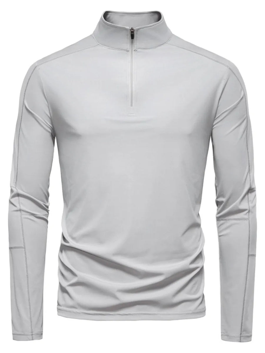 Gray performance zip-neck tee with structured shoulders and long sleeves.