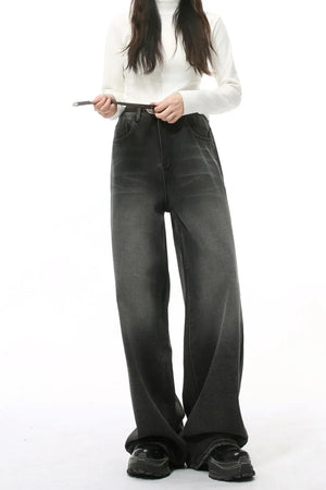 Wide leg vintage wash denim jeans in dark color with a relaxed fit.